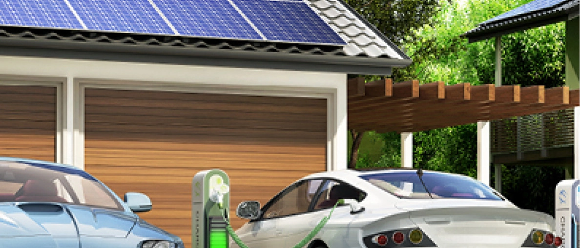Auto wird geladen vor Garage mit PV-Modulen