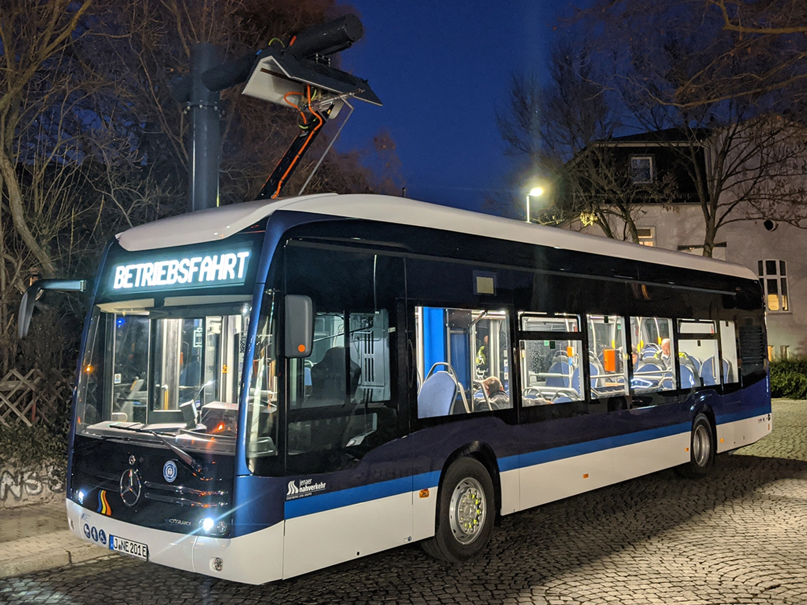 ein Elektrobus des Jenaer Nahverkehr parkt nachts am Westbahnhof in Jena