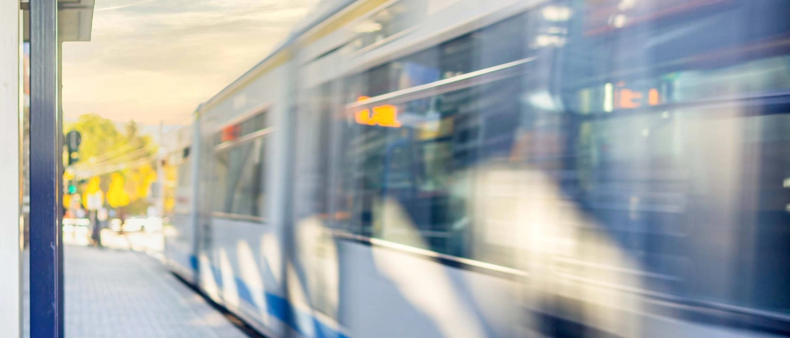 Eine Straßenbahn fährt von einer Haltestelle ab.