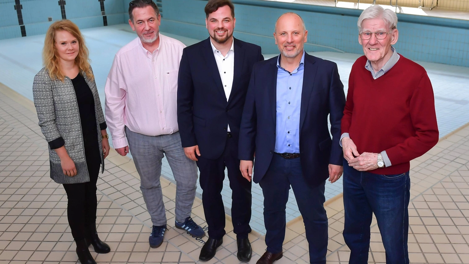 Gruppenbild vor dem Becken: In der ehemaligen Schwimmhalle Lobeda-West: Katrin Hitziggrad von „Blank – Agentur für Zwischennutzung“, Jörg Hühn, Geschäftsführer der reCoVer Stiftung Jena, Johannes Schleußner, Dezernent für Bildung, Jugend, Kultur und Sport, Bernhard Dengel, Geschäftsführer der Jenaer Bäder, und Volker Blumentritt, Ortsteilbürgermeister Lobeda (v. l. n. r.), stellten Perspektiven für die zukünftige Nutzung des Gebäudes vor.
