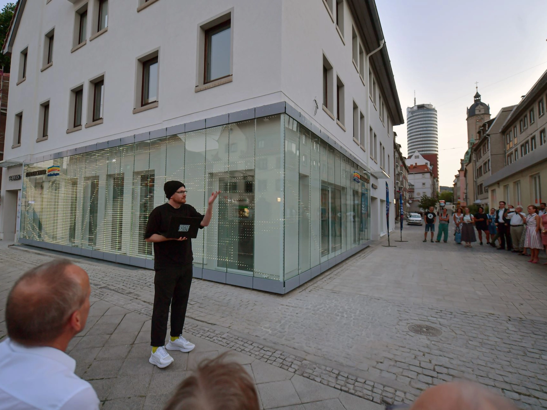 Eine Person steht vor dem Kundencenter und hält einen Vortrag