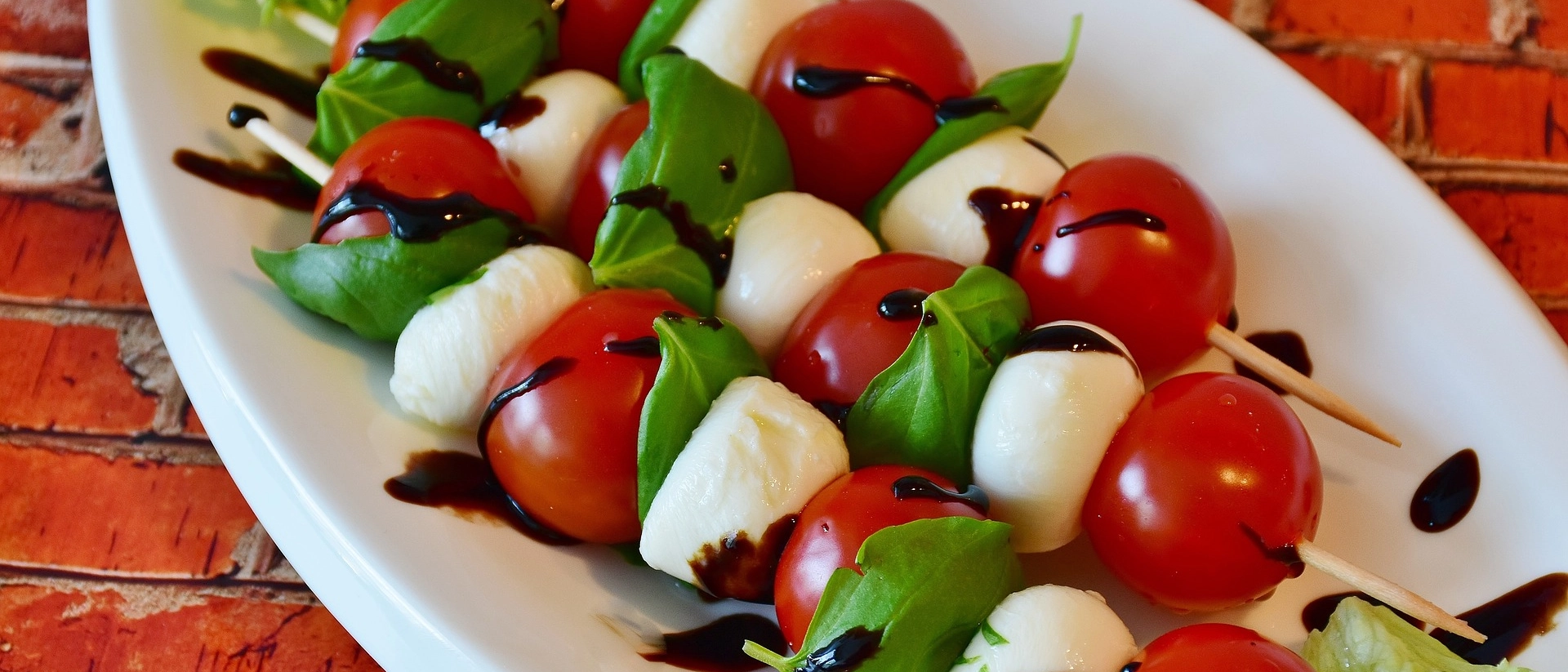 Ein Beispielbild für Tomate-Mozzarella-Spieße auf einem Teller. Ein Beispielbild für Tomate-Mozzarella-Spieße auf einem Teller.