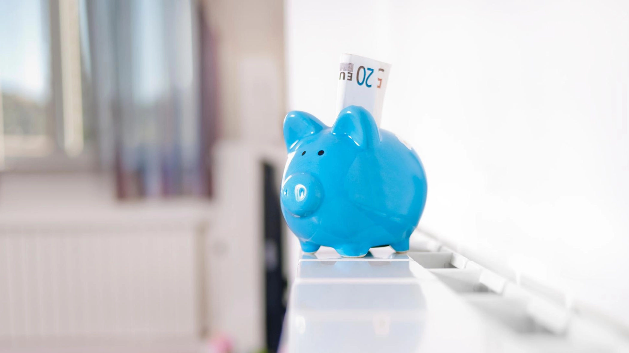 Ein Sparschwein steht auf einer Heizung